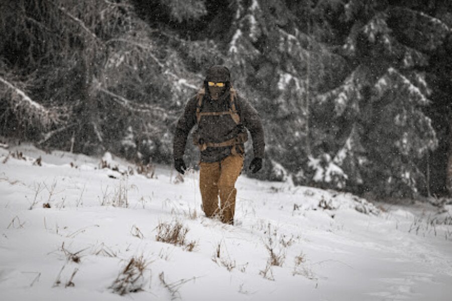 Hegyi turista mély hóban sétál csökkent látási viszonyok között téli túra során. Foto: Rigad